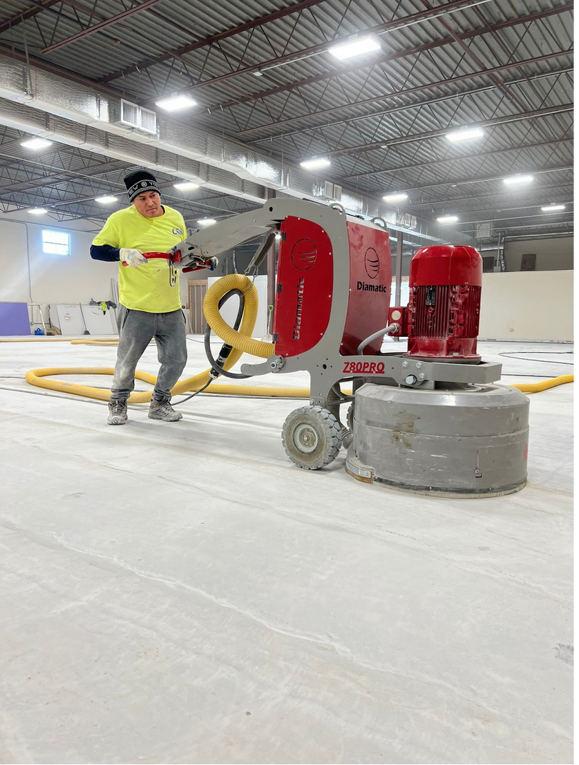 Worker applying self leveling concrete